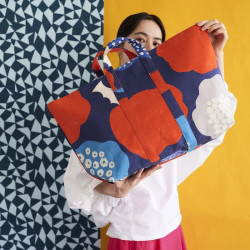 Echino cotton linen canvas fabric with red, blue and natural stylised flowers