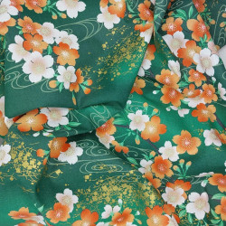 Green Japanese fabric with white, ornage and gold cherry blossom patterns