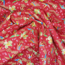 Japanese fabric with origami cranes and flowers on a red background