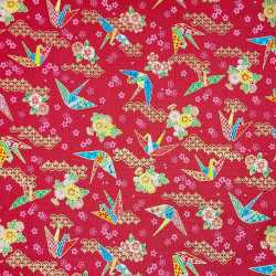 Japanese fabric with origami cranes and flowers on a red background
