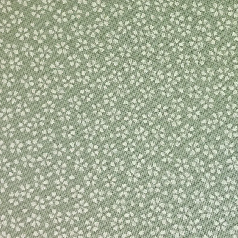 Spring green fabric with small cherry blossom patterns